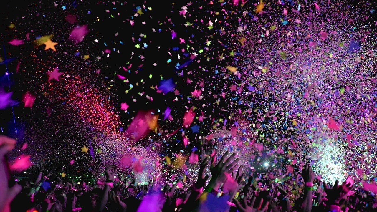 Concert party with confetti falling all over the packed crowd