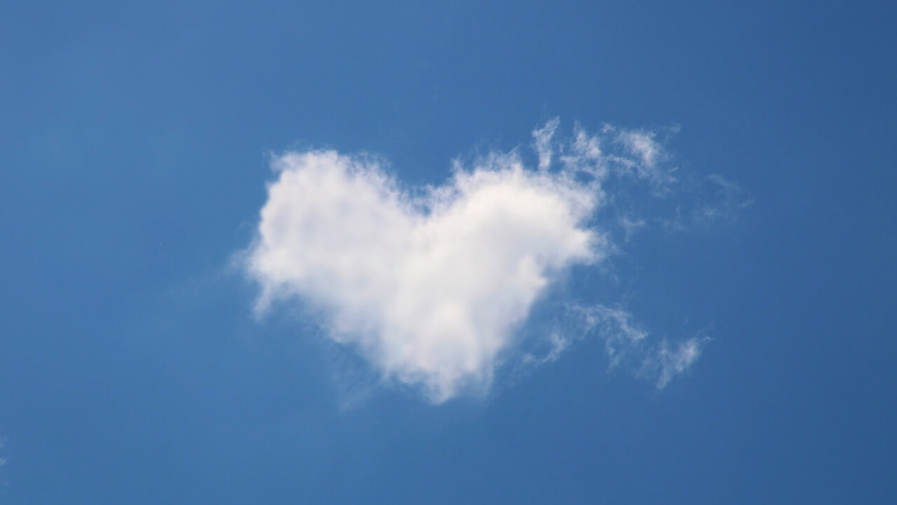 Clouds shaped like a heart in the bright blue sky