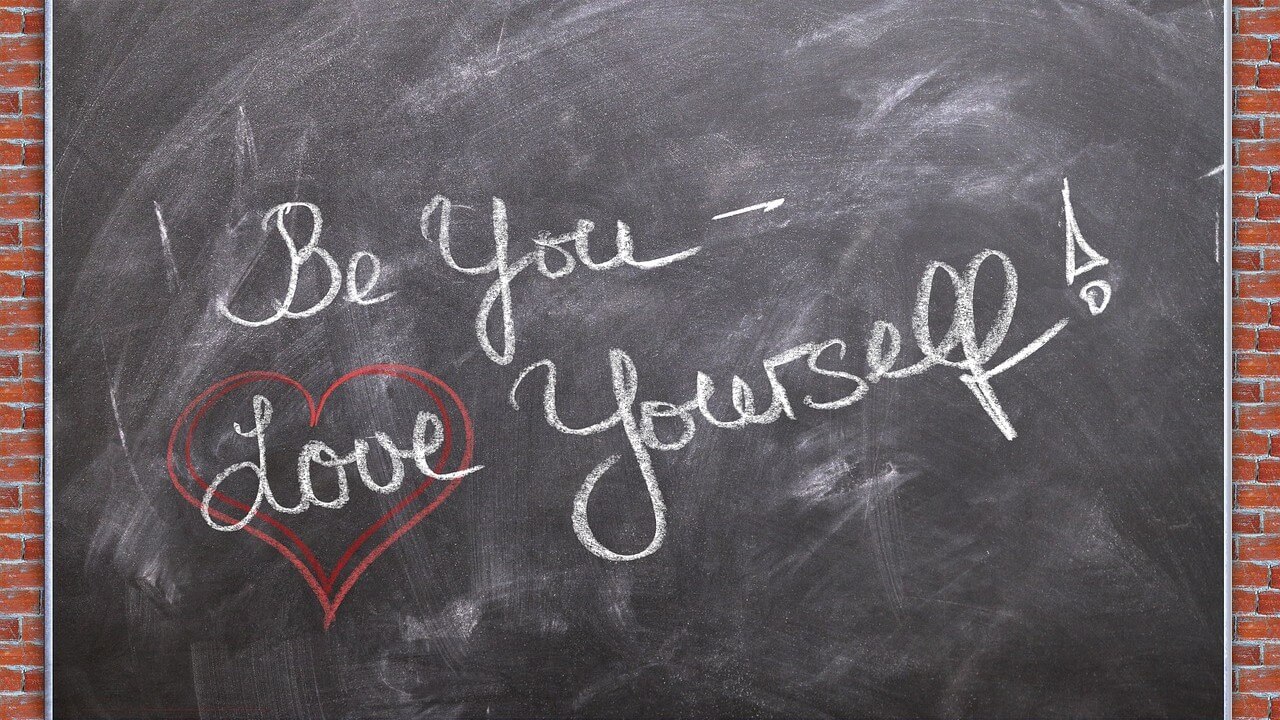 Chalkboard with writing in cursive saying Be You and Love Yourself